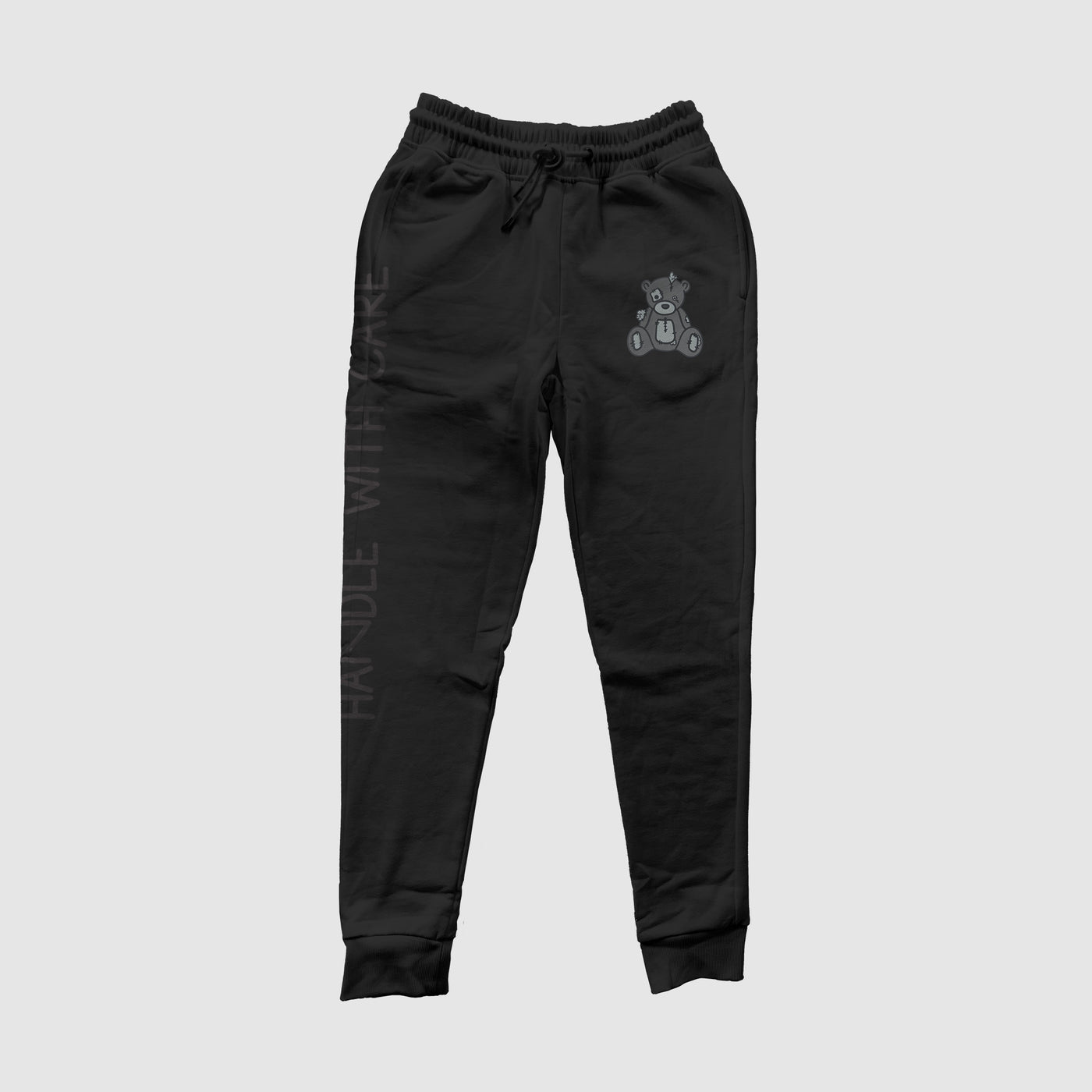 Handle With Care Blackout Jogger Pants
Our Handle with Care Joggers feature Patches the Dream Teddy Bear. Patches is a reminder that we're capable of overcoming anything that comes our way. It's a gentleDREAM Clothing 